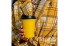 Woman holding a coffee cup.