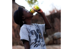 child drinking soda from a can