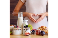Image Products with dietary fibers and woman holding her hands over her stomach.