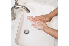Image Washing hands in a sink.