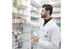 Image Pharmacist checks shelves.