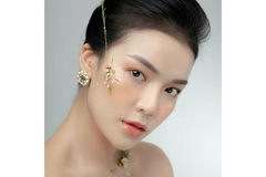 Image An Asian women staring into the camera with a flower dangling in front of her face.