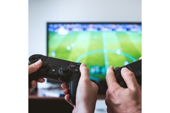 Image People playing PlayStation on television.