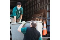 Image waste collectors loading a grey bin into the lorry