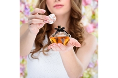 Image Woman shows perfume.