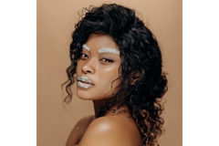 Image A girl with glitter lips and eyebrows.