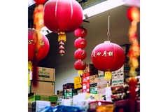 red lanterns hanging in chinese shop with packaging boxes up against the wall