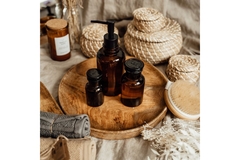 Image Three general cosmetic bottles on a tray surrounded by towels.