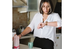 Image Woman checking her smartwatch before eating something.