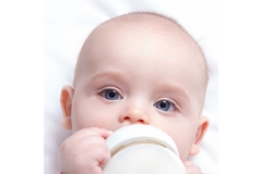 Image Baby drinks from bottle.