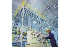 Worker in plastic recycling facility.