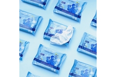 Image Packs of wet wipes organized in diagonals with one packet open.