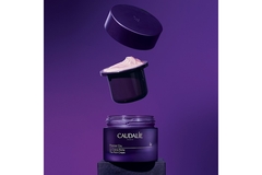 Image Purple glass refillable cream packaging.