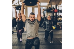 Image Man and two women weightlifting in a gym.