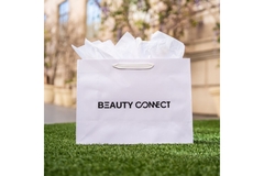 Image Plain rectangular shopping bag on grass with beauty connect written on it.