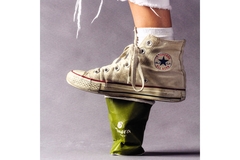 Image person wearing white converse crushing a paper cup