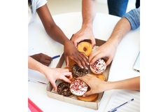 Image Hands taking donuts.