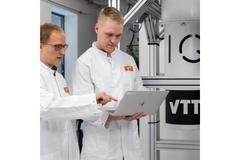 Image Researchers in lab looking at laptop.