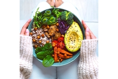 Image A bowl of food is held by a person.