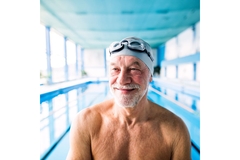 Senior man in an indoor swimming pool.
