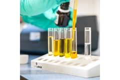 A scientist putting oils in vials.