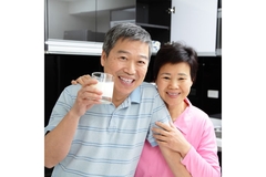 Image Happy seniors couple drink milk.