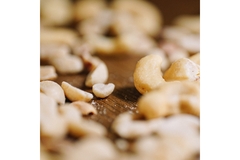 Image Cashew nuts are spread out on a table.