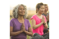 Image Two women doing yoga outside, relaxing.