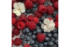 Two white flowers raspberries and blueberries.