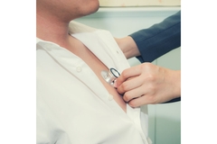 Image Doctor checking a patient's heart rate.