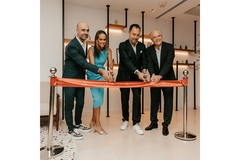 Image Four people cutting a orange ribbon.