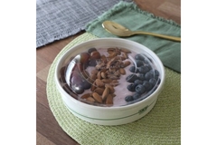 Bowl with nuts, fruit and yogurt.