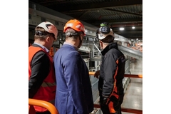 Image three workers looking at the Site Zero facility in Sweden from the first floor balcony