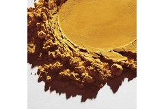 Image Yellow powder spread out on a white table.