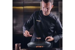 Image A chef is dressed in black.