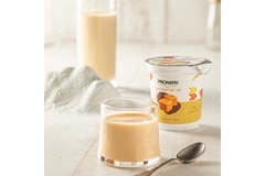 Image Two cups of protein milk are placed next to a plastic cup of dairy products.