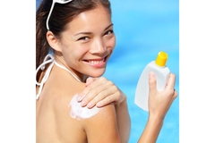 Image A woman applying sunblock.