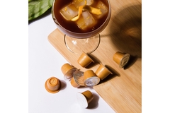 Image coffee cocktail next to a few coffee capsules