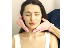 Image A woman receiving a consultation in a cosmetic surgeon's office.