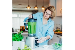 Woman making a healthy smoothie.