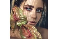 Image A female model posing with tropical rainforest flowers.