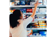 woman at a pharmacy picking medicine