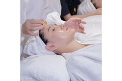 Image A woman getting a serum put on her face.