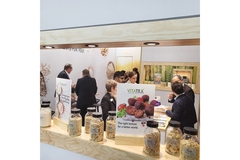 Visitors at a trade show booth.