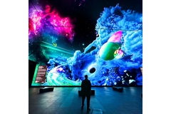Image A giant digital display constructed by Lush featuring giant mushrooms and galaxies.
