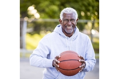 Image Elderly man holding a basketball.