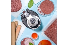 A microscope surrounded by a variety of meat products.