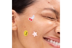 Image A woman with Starface acne stickers on her face.