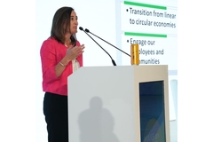 Woman speaking in front of audience.
