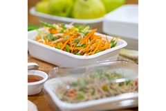 Image Boxes of food has been placed on a wooden table.